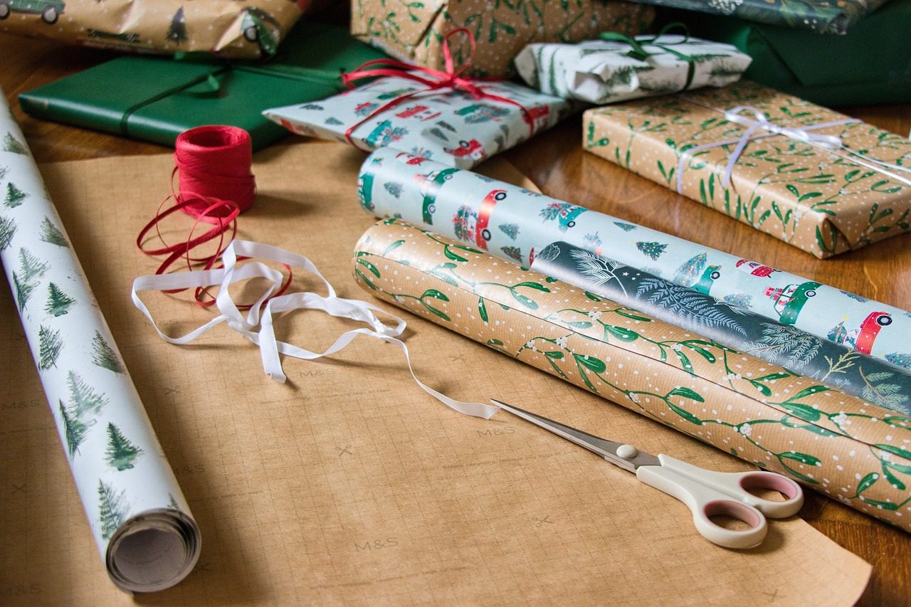 Christmas presents wrapped in kraft paper with red ribbon